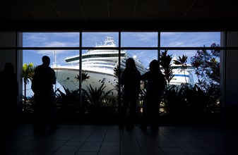 WEST INDIES, Grenada, St George, Tourists in the terminal building looking at the cruise ship
