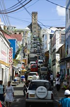 WEST INDIES, Grenada, St George, St Juille Street with overhead power cables busy with traffic and