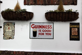 IRELAND, North, Belfast, "Cathedral Quarter, Commerical Court, Old metal Guinness signs decorating