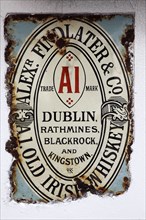 IRELAND, North, Belfast, "Cathedral Quarter, Commerical Court, Old metal whiskey sign decorating