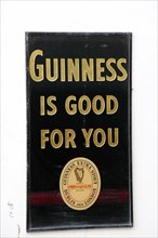 IRELAND, North, Belfast, "Cathedral Quarter, Commerical Court, Old metal Guinness sign decorating