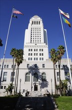 USA, California, Los Angeles, City Hall with flags in the foreground.