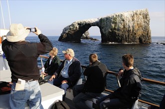 USA, California, Anacapa Island, "Tour boat passing Arch Rock, East Anacapa, Channel Isles"