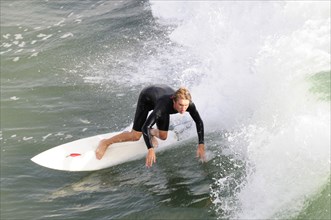 USA, California, Los Angeles, Surfer riding waves at Manhattan Beach
