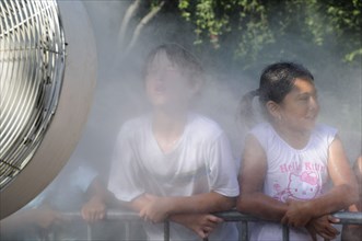 USA, California, Los Angeles, "Children cooling off at the water spray, LA Zoo, Griffith Park"