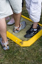 ENGLAND, West Sussex, Findon, Findon village Sheep Fair People walking through a foot bath at a Bio