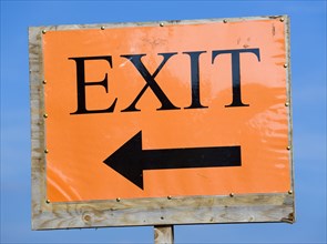 ENGLAND, West Sussex, West Dene, An orange sign with black writing that reads Exit and has an arrow