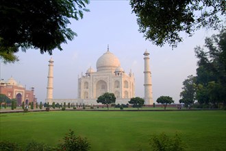 INDIA, Uttar Pradesh, Agra, Taj Mahal at sunrise one of the wonders of the world.  Exterior facade