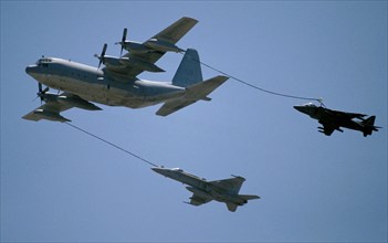 TRANSPORT, Air, Jet Fighter, Two Jets being refueled in mid air by C-130 Hecules.