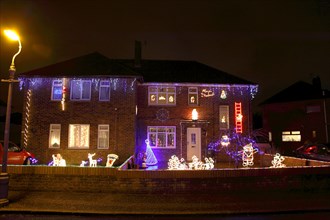 ENGLAND, West Sussex, Southwick, Cul de Sac of houses decorated with fairy lights for Christmas.
