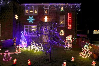 ENGLAND, West Sussex, Southwick, Cul de Sac of houses decorated with fairy lights for Christmas.