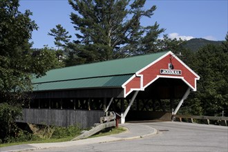 USA, New Hampshire, Jackson, Wooden Covered Bridge number 51. Green roof and red entrance