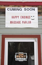 USA, New Hampshire, Keene, "Sign on building, cuming soon, Happy Endings Massage Parlor."
