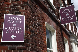 ENGLAND, East Sussex, Lewes, "High Street, Lewes Castle museum and shop signs. "