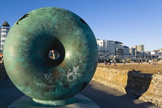 ENGLAND, East Sussex, Brighton, The green bronze Doughnut sculpture on one of the groynes on the