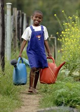 SWAZILAND, Agriculture, Irrigation, Young Girl Collecting water with watering cans