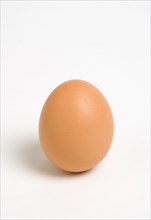 FOOD, Uncooked, Eggs, One hard boiled free range egg on a white background.