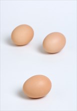 FOOD, Uncooked, Eggs, Three free range eggs on a white background.