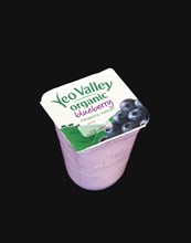 FOOD, Organic, Yogurt, Yeo Valley organic probiotic blueberry yogurt on a black background.