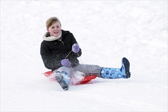 WEATHER, Winter, Snow, "Young girl sledding down hill. Perth, Scotland."