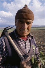 TURKEY  Antalya Portrait of farmer carrying hoe over his shoulder.EurasiaEuropean Middle East