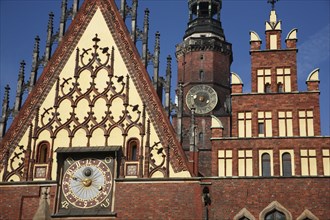 Poland, Wroclaw, Town Hall with decorative gable, red  brickwork, sundial with the clock tower of