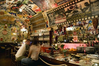 ITALY, Tuscany, Siena, The Bella Vista Social Pub Cuban theme bar interior with people sitting on