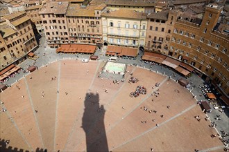 ITALY, Tuscany, Siena, Shadow of the Torre del Mangia campanile belltower in the Piazza del Campo