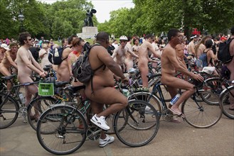 ENGLAND, London, Hyde PArk, Naked people riding their bicycles on formation at Hyde Park while