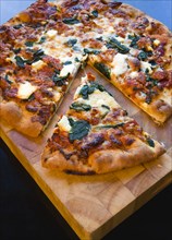 Food, Cooked, Pizza, Italian spinach and ricotta cheese pizza on wooden cutting board with a slice