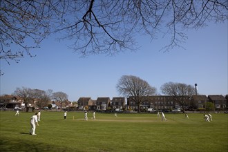 England, West Sussex, Southwick, Local Cricket team playing on village green.