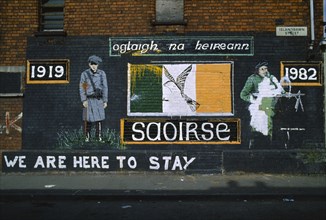 Ireland, North, Belfast, Irish Republican mural on the side of a terrace house on the corner with