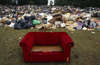Environment, Litter, Red sofa surrounded by a mountain of other rubbish dumped in a public park