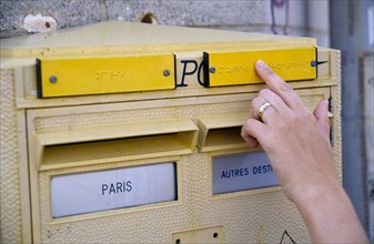 France, Ile de France, Paris, Letter post box with Braille incription for the blind and a female