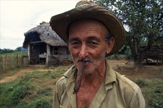 CUBA, Vinales, Pinar del Rio, Portrait of tobacco farmer smoking cigar.