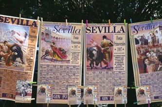 Spain, Andalucia, Seville, Posters and tickets for a bullfight hanging from a line outside the