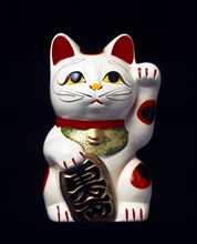 Japan, Honshu, Kyoto, Traditional statue of Maneki Neko Beckoning Cat associated with good luck and