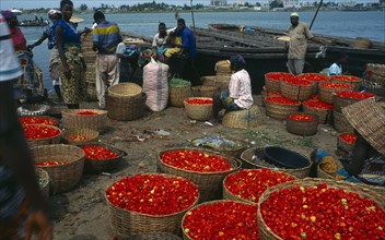 BENIN, Cotonou, Grand Marche de Dantokpa at the waters edge.  Baskets of red peppers, people and