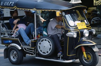 Thailand, North, Chiang Mai, Local family with young child as passengers in a Tuk Tuk three wheeled