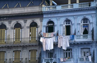 Cuba, Habana, Havana, Colourful colonial buildings along the Malecon with washing hanging from
