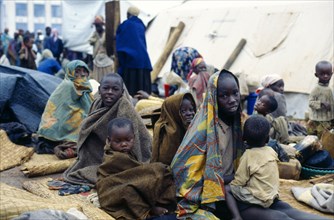 Congo, Bukavu, Rwandan refugees wrapped in blankets without shelter.