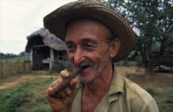 CUBA, Vinales, Portrait of tobacco planter smoking cigar.