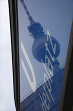 Germany, Berlin, U Bahn sign for Alexanderplatz with Fernsehturm reflected  in the glass