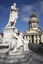 Germany, Berlin, Gendermenmarkt, Schiller Monument with the Franzosischer Dom in the background.