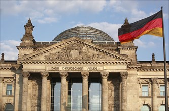 Germany, Berlin, Reichstag with the national flag to the right.