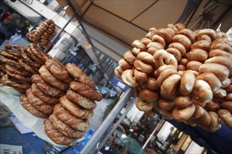 Poland, Krakow, Obwarzaneck, street vendors stall selling twisted rings of bread strewn with poppy