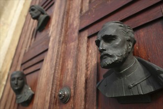 Poland, Krakow, busts on the doors of the Mariacki Basilica or Church of St Mary.