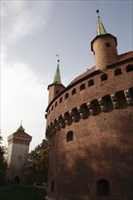 Poland, Krakow, turrets of the Barbican fortress with St Florian's gate in the background left.