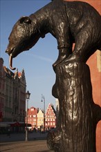 Poland, Wroclaw, replica of E. M. Geygers fountain with bronze cast bear, superstitious tourists