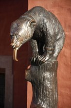 Poland, Wroclaw, replica of E. M. Geygers fountain with bronze cast bear, superstitious tourist